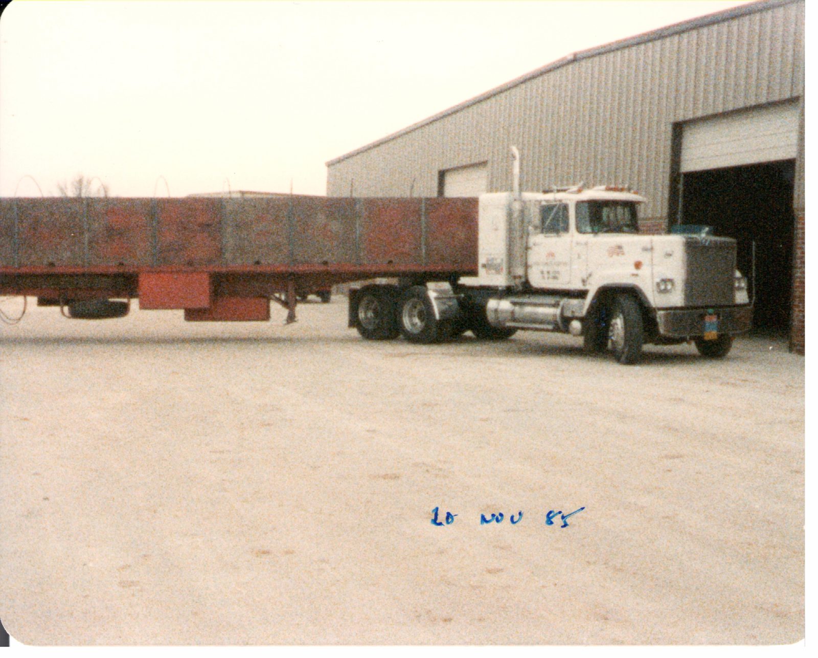The first flatbed backs up to the new dock.